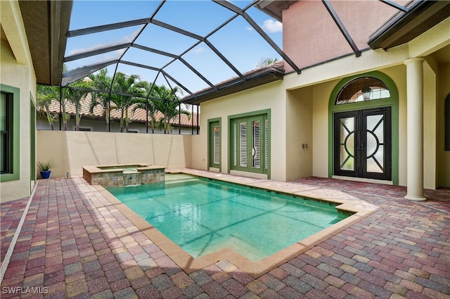 6528 Costa Cir, Naples, FL 34113 - view of swimming pool with a pool with connected hot tub, a patio, glass enclosure, and french doors