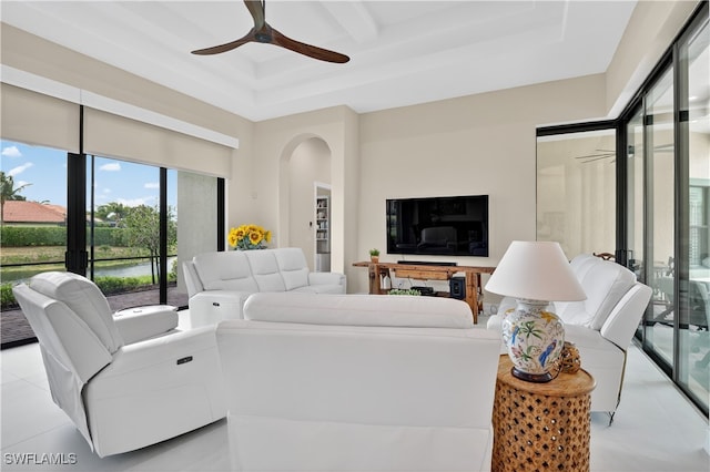 6528 Costa Cir, Naples, FL 34113 - living room with a ceiling fan, arched walkways, coffered ceiling, beamed ceiling, and tile patterned flooring