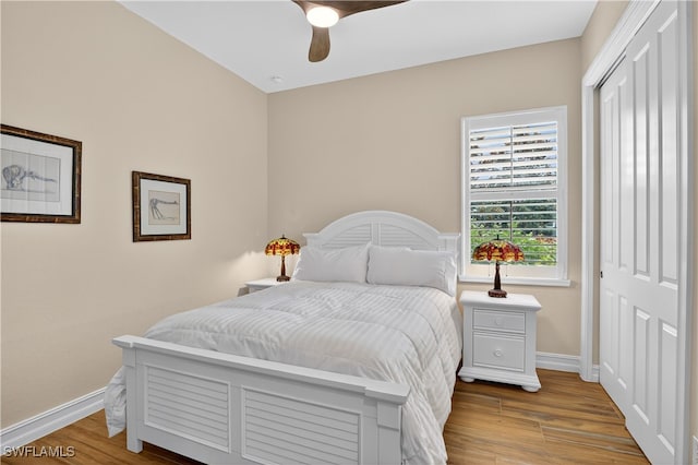 6528 Costa Cir, Naples, FL 34113 - bedroom with a closet, wood finished floors, baseboards, and ceiling fan