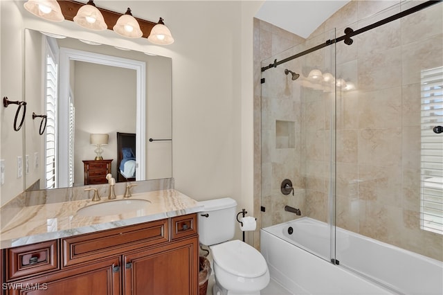 6528 Costa Cir, Naples, FL 34113 - ensuite bathroom with vanity, shower / bath combination with glass door, toilet, plenty of natural light, and lofted ceiling