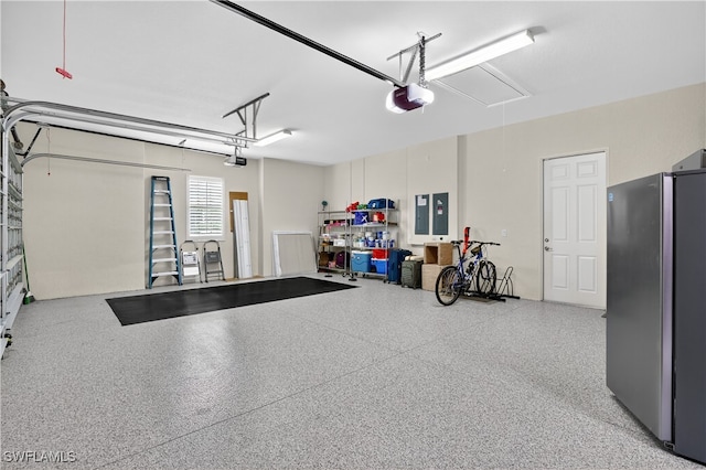 6528 Costa Cir, Naples, FL 34113 - garage with freestanding refrigerator, electric panel, and a garage door opener