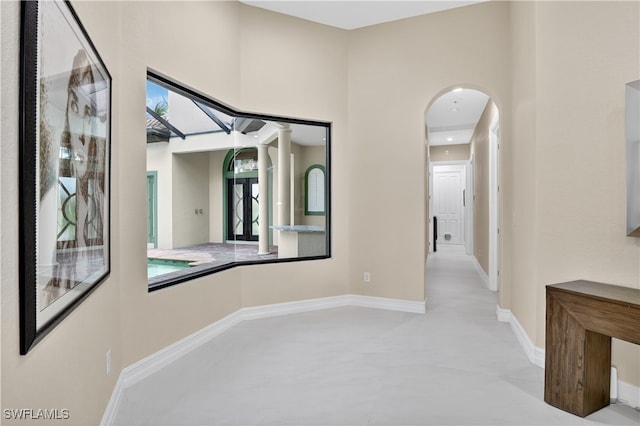 6528 Costa Cir, Naples, FL 34113 - corridor featuring arched walkways and baseboards