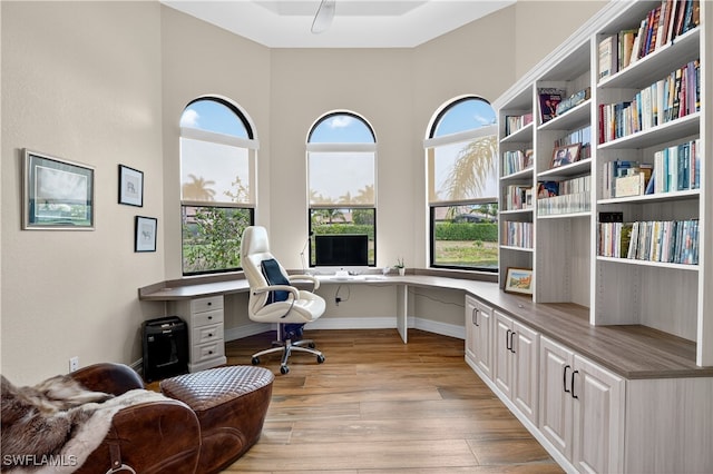 6528 Costa Cir, Naples, FL 34113 - office space featuring built in study area, light wood finished floors, ceiling fan, baseboards, and a high ceiling