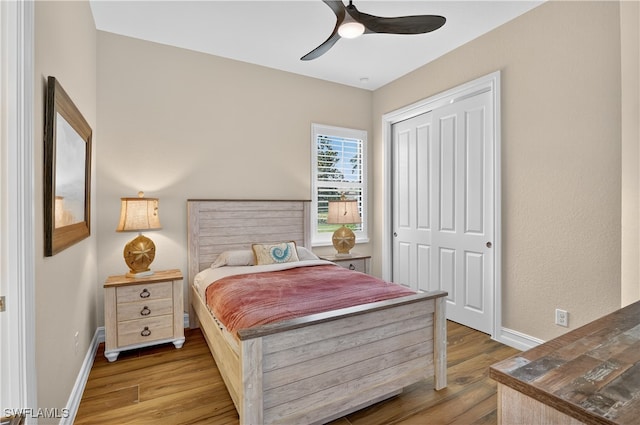 6528 Costa Cir, Naples, FL 34113 - bedroom with wood finished floors, baseboards, a closet, and a ceiling fan