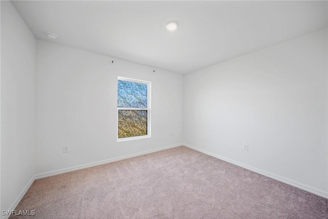 3002 NW 3rd Pl, Cape Coral, FL 33993 - empty room featuring carpet flooring, baseboards, and a smoke detector