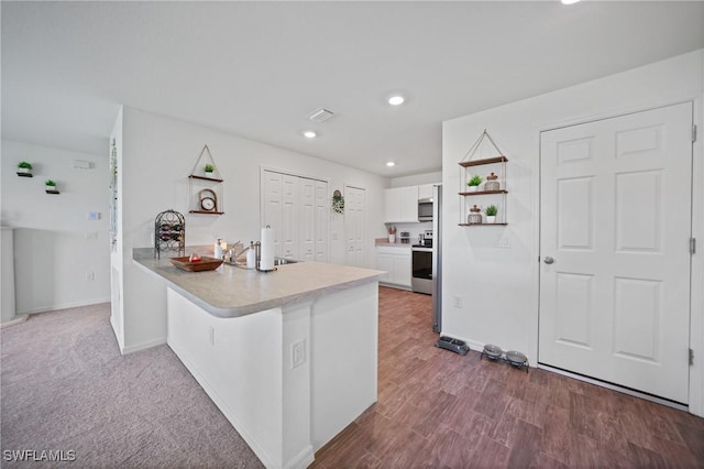 3002 NW 3rd Pl, Cape Coral, FL 33993 - kitchen featuring stainless steel appliances, white cabinets, open shelves, a peninsula, and light countertops