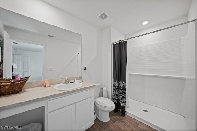 3002 NW 3rd Pl, Cape Coral, FL 33993 - bathroom featuring toilet, vanity, curtained shower, and wood finished floors