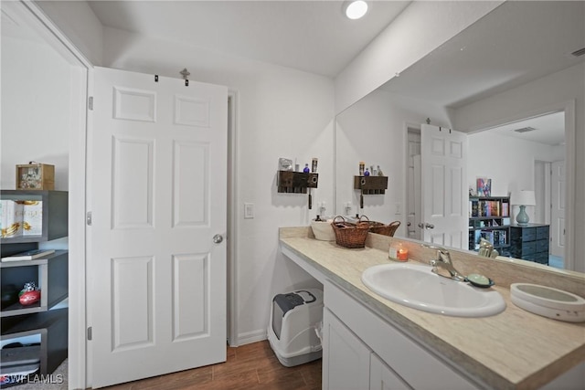3002 NW 3rd Pl, Cape Coral, FL 33993 - bathroom with vanity, wood finished floors, and baseboards