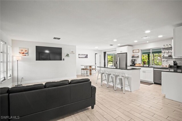 2001 Bahama Ave, Fort Myers, FL 33905 - living room featuring plenty of natural light, recessed lighting, and light wood-style floors