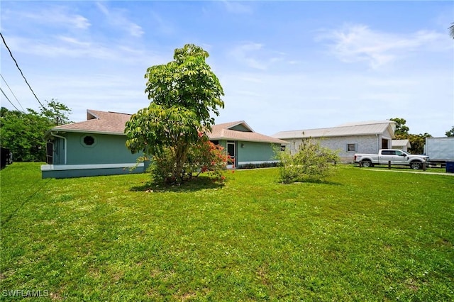 2001 Bahama Ave, Fort Myers, FL 33905 - rear view of house with a yard and stucco siding