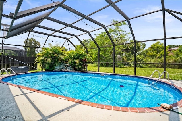 2001 Bahama Ave, Fort Myers, FL 33905 - swimming pool featuring a yard, glass enclosure, and a patio