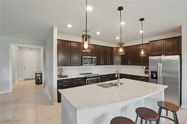 4934 Seton Way, Ave Maria, FL 34142 - kitchen featuring appliances with stainless steel finishes, a sink, dark brown cabinetry, baseboards, and light countertops