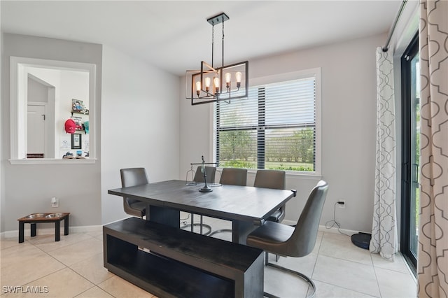 4934 Seton Way, Ave Maria, FL 34142 - dining room with light tile patterned flooring, a chandelier, and baseboards