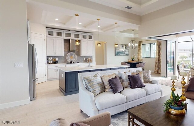 4426 Vasco St, Punta Gorda, FL 33950 - living room with a chandelier, light wood-type flooring, coffered ceiling, recessed lighting, and beam ceiling