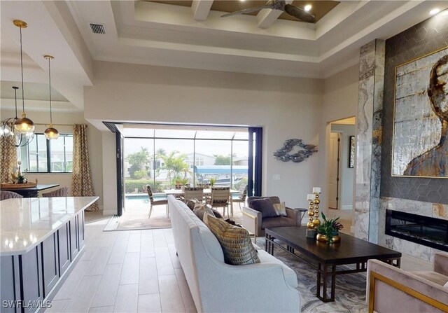 4426 Vasco St, Punta Gorda, FL 33950 - living room with a towering ceiling, a ceiling fan, a raised ceiling, and a high end fireplace