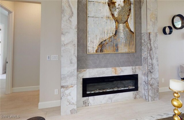 4426 Vasco St, Punta Gorda, FL 33950 - detailed view of a tile fireplace, baseboards, and wood finished floors