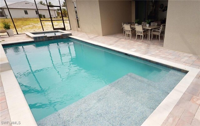 4426 Vasco St, Punta Gorda, FL 33950 - view of pool with a patio area, a pool with connected hot tub, a lanai, and outdoor dining space