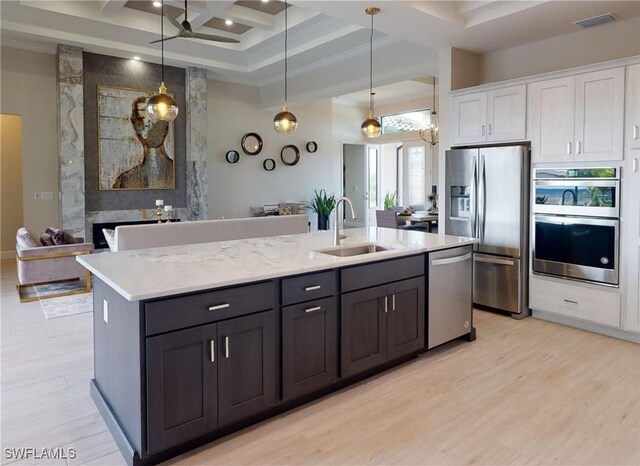 4426 Vasco St, Punta Gorda, FL 33950 - kitchen featuring a sink, stainless steel appliances, white cabinetry, light wood-style floors, and coffered ceiling