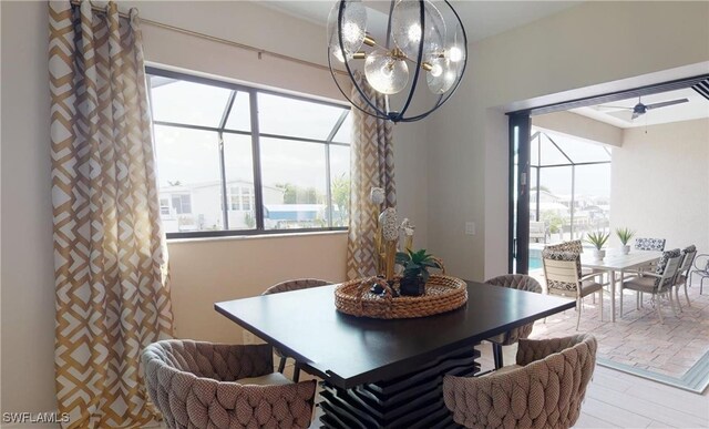 4426 Vasco St, Punta Gorda, FL 33950 - dining room with a chandelier, a sunroom, and a ceiling fan