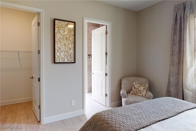 4426 Vasco St, Punta Gorda, FL 33950 - bedroom with a walk in closet, wood finished floors, and baseboards