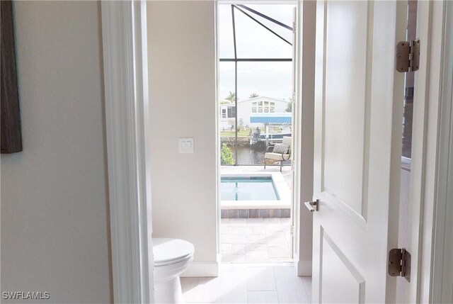 4426 Vasco St, Punta Gorda, FL 33950 - bathroom featuring toilet, tile patterned floors, and a water view