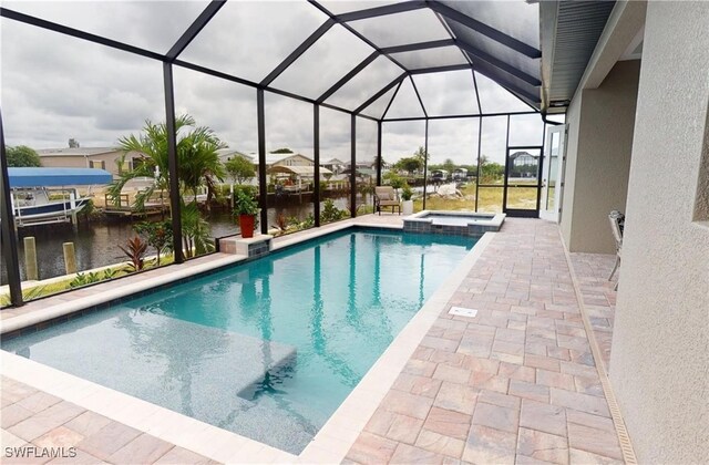 4426 Vasco St, Punta Gorda, FL 33950 - view of swimming pool with a patio, a pool with connected hot tub, a water view, and a lanai