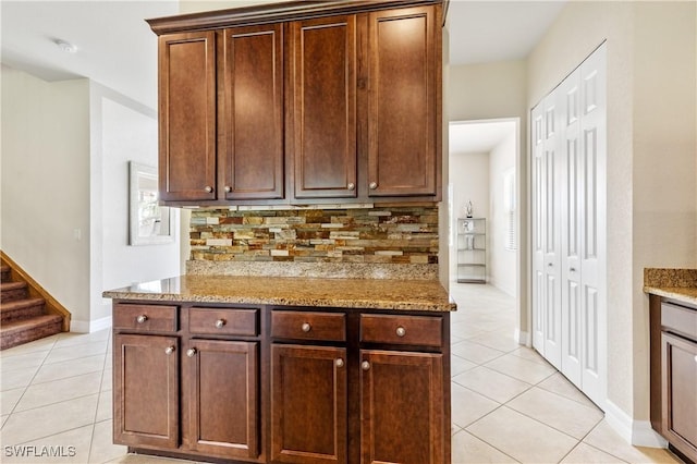 11164 Sparkleberry Dr, Fort Myers, FL 33913 - kitchen with light tile patterned floors, decorative backsplash, and light stone counters