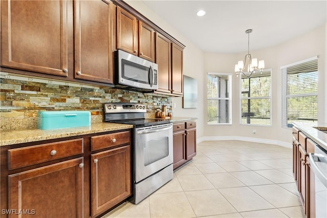 11164 Sparkleberry Dr, Fort Myers, FL 33913 - kitchen with appliances with stainless steel finishes, a chandelier, decorative backsplash, baseboards, and recessed lighting
