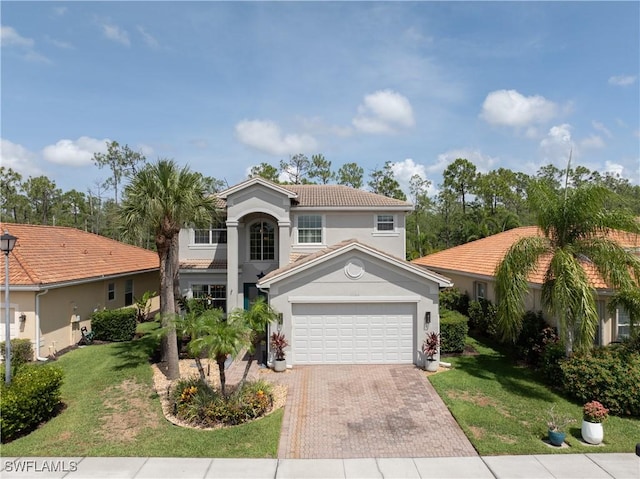 11164 Sparkleberry Dr, Fort Myers, FL 33913 - mediterranean / spanish home with decorative driveway, a garage, a front lawn, and stucco siding