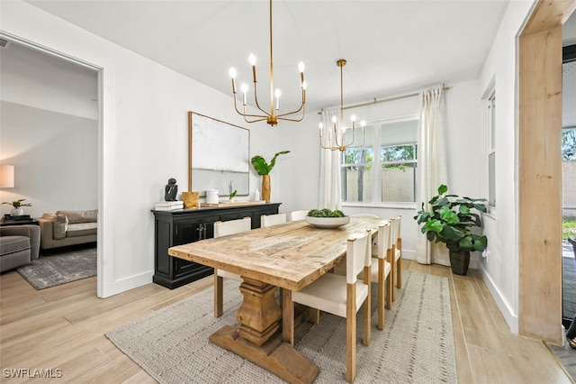 21282 Braxfield Loop, Estero, FL 33928 - dining area with a chandelier, light wood-type flooring, and baseboards