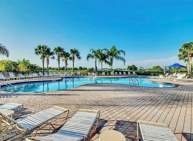 10329 Canal Brook Ln, Lehigh Acres, FL 33936 - community pool with a patio