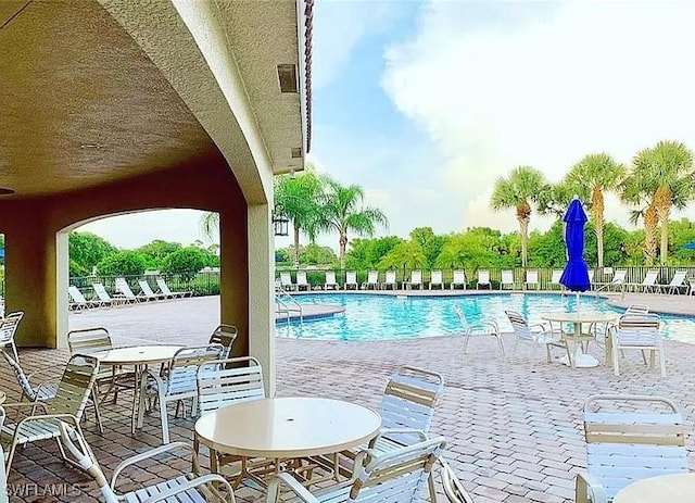 10329 Canal Brook Ln, Lehigh Acres, FL 33936 - community pool featuring a patio area