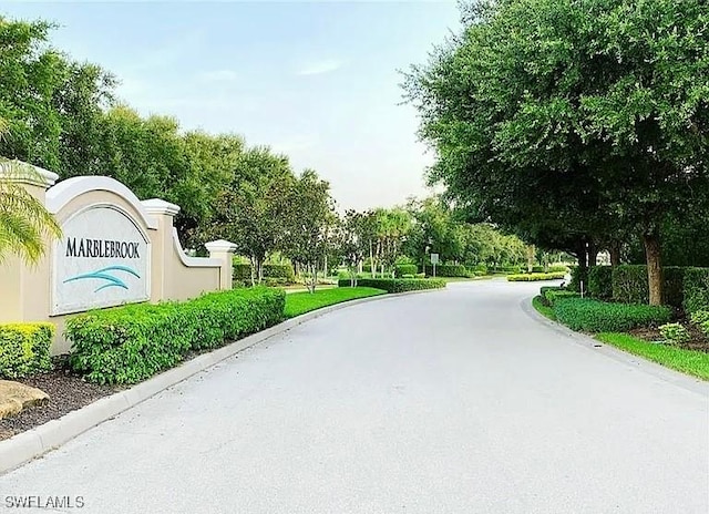 10329 Canal Brook Ln, Lehigh Acres, FL 33936 - view of asphalt road with curbs