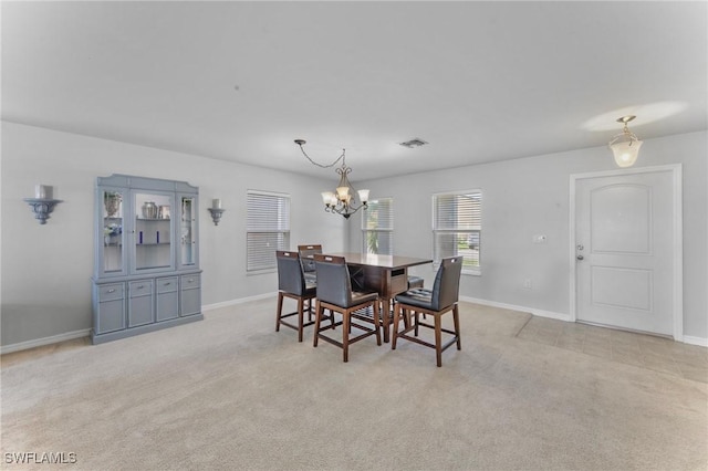 10329 Canal Brook Ln, Lehigh Acres, FL 33936 - dining room with a chandelier, light colored carpet, and baseboards