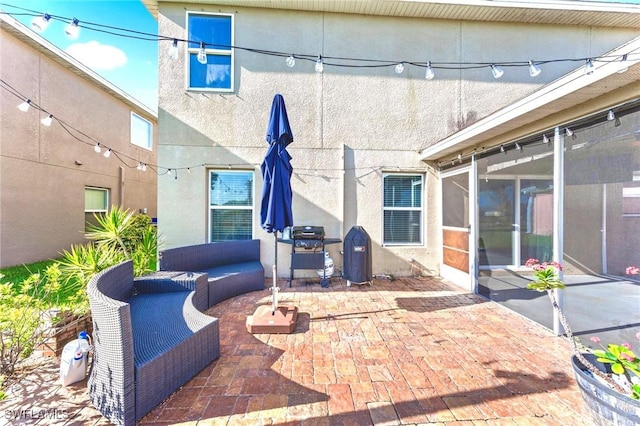 10329 Canal Brook Ln, Lehigh Acres, FL 33936 - view of patio / terrace with a sunroom, an outdoor hangout area, and area for grilling