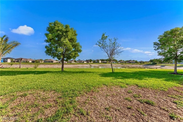 10329 Canal Brook Ln, Lehigh Acres, FL 33936 - view of green lawn with a water view