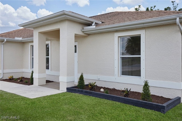 314 Pennfield St, Lehigh Acres, FL 33974 - doorway to property with a shingled roof and stucco siding