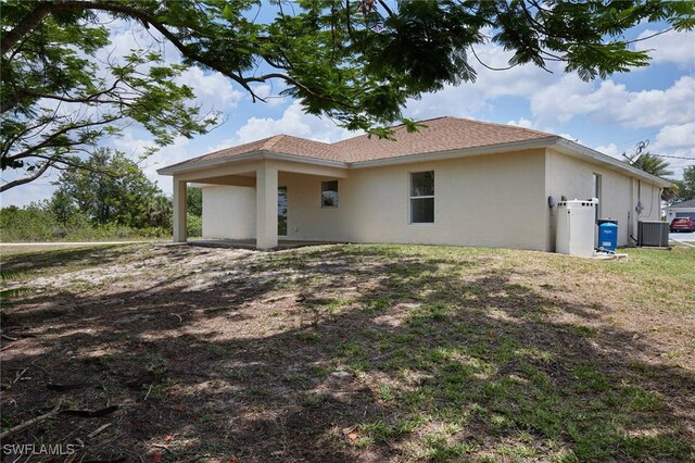 314 Pennfield St, Lehigh Acres, FL 33974 - view of home's exterior featuring stucco siding and central AC