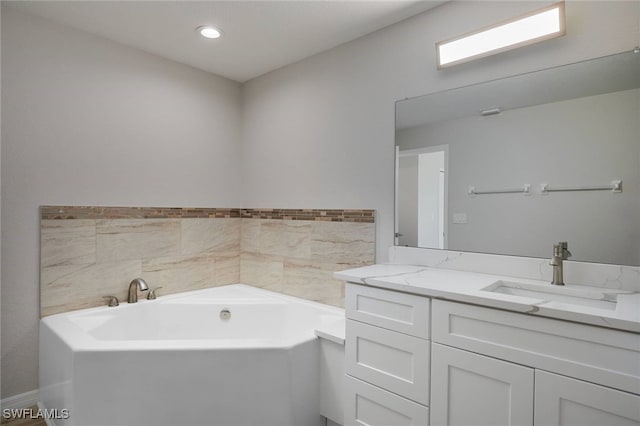 314 Pennfield St, Lehigh Acres, FL 33974 - bathroom with vanity, a garden tub, and recessed lighting