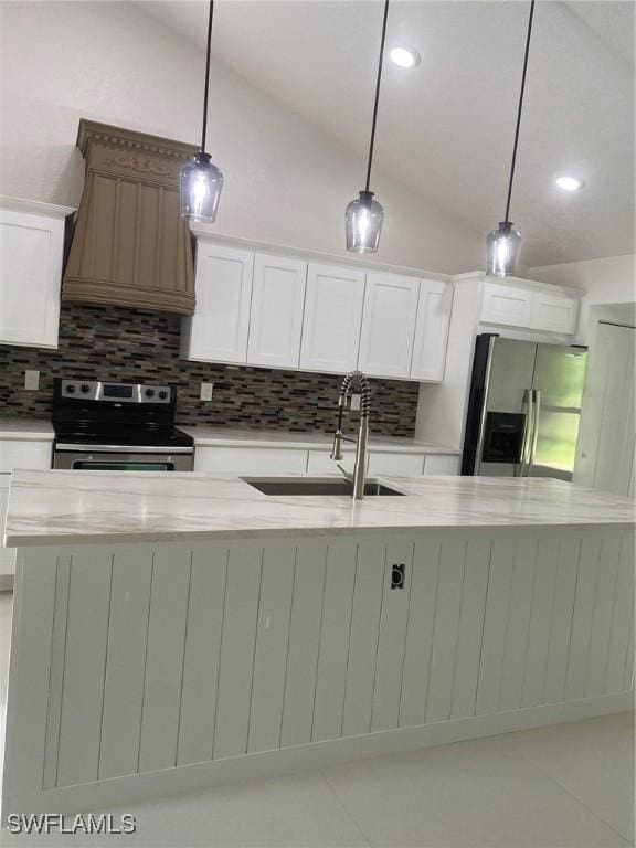 1640 8th St NE, Naples, FL 34120 - kitchen featuring stainless steel appliances, lofted ceiling, backsplash, a sink, and white cabinetry
