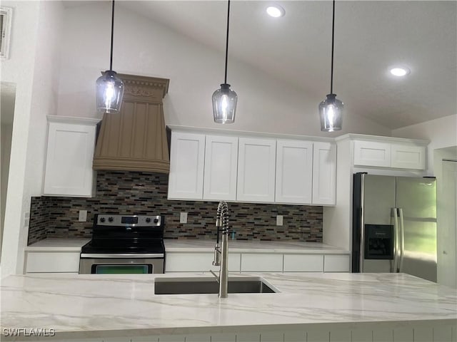 1640 8th St NE, Naples, FL 34120 - kitchen with appliances with stainless steel finishes, vaulted ceiling, a sink, decorative backsplash, and white cabinets