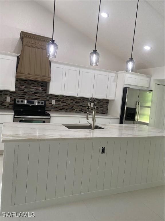 1640 8th St NE, Naples, FL 34120 - kitchen featuring appliances with stainless steel finishes, lofted ceiling, tasteful backsplash, a sink, and white cabinetry