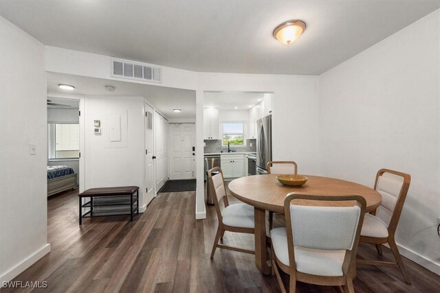 499 Forest Lakes Blvd Unit 306, Naples, FL 34105 - dining space with dark wood finished floors and baseboards