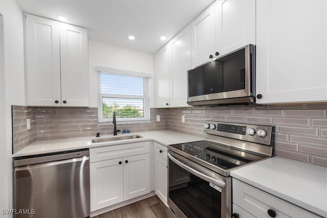 499 Forest Lakes Blvd Unit 306, Naples, FL 34105 - kitchen featuring stainless steel appliances, a sink, white cabinets, light countertops, and recessed lighting