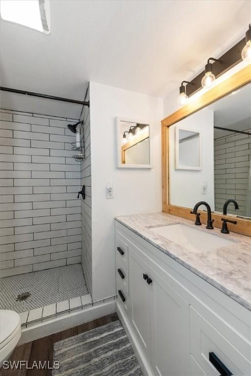 499 Forest Lakes Blvd Unit 306, Naples, FL 34105 - full bath featuring vanity, toilet, a shower stall, and wood finished floors
