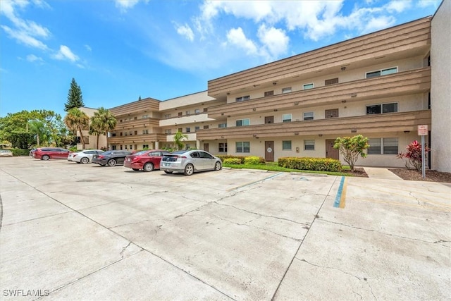 499 Forest Lakes Blvd Unit 306, Naples, FL 34105 - view of property featuring uncovered parking