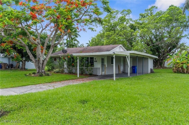 322 New York Dr, Fort Myers, FL 33905 - view of front of house with a front lawn, a carport, and driveway