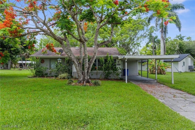 322 New York Dr, Fort Myers, FL 33905 - single story home with a front lawn, asphalt driveway, and an attached carport