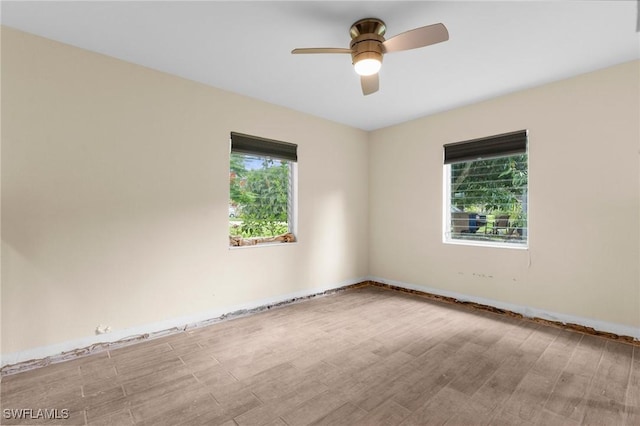 322 New York Dr, Fort Myers, FL 33905 - empty room with wood finished floors, a ceiling fan, and baseboards