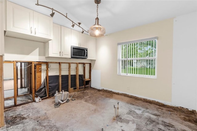 322 New York Dr, Fort Myers, FL 33905 - unfurnished living room with unfinished concrete flooring and baseboards